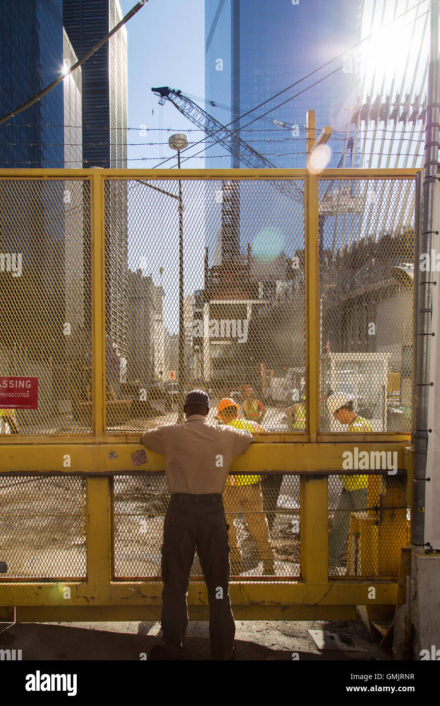 New York City, NY, USA - November 24, 2014. Man observing workers in the 9/11 memorial area. Stock Photo
