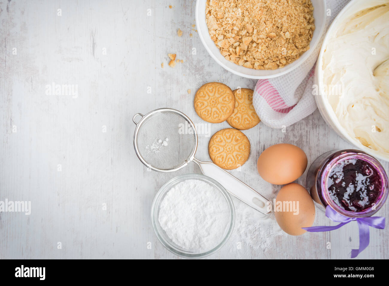 Blueberry cheese cake ingredients prepared over a white wood background. Stock Photo