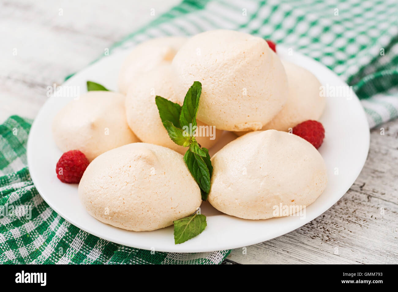 Meringues with raspberry and mint leaves Stock Photo Alamy