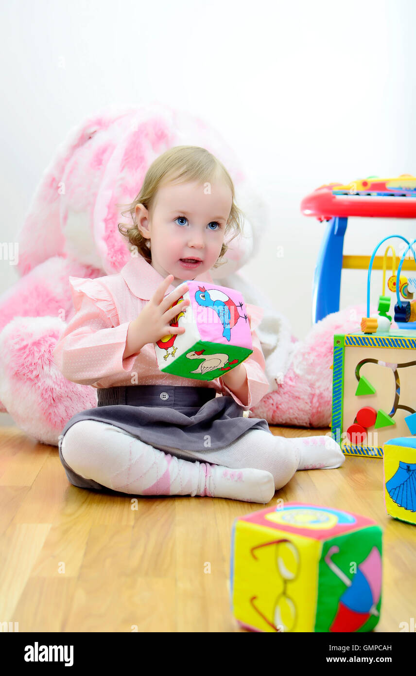 little girl in a room with toys Stock Photo - Alamy