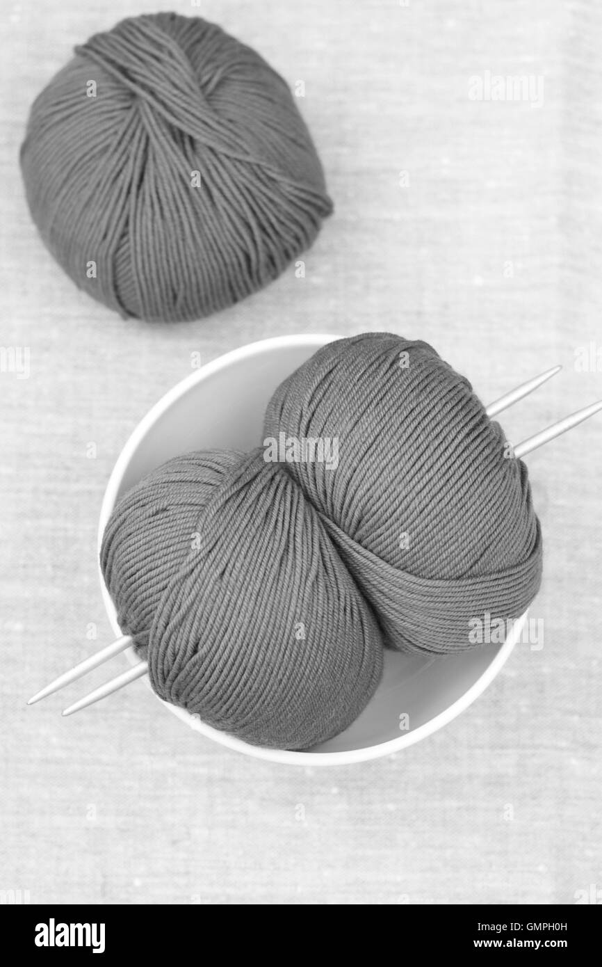 Three balls of yarn and knitting needles Stock Photo