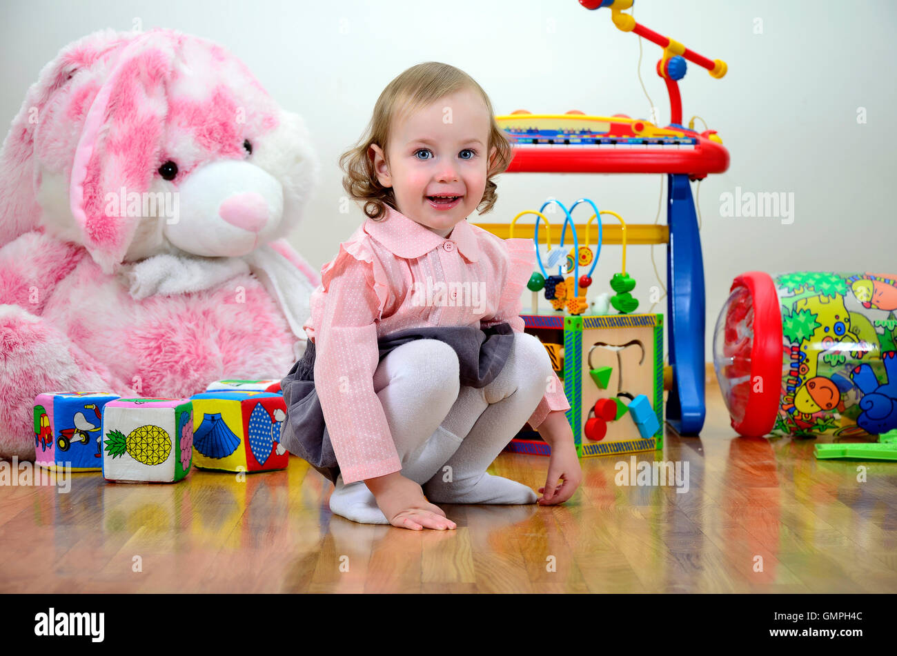 little girl in a room with toys Stock Photo - Alamy