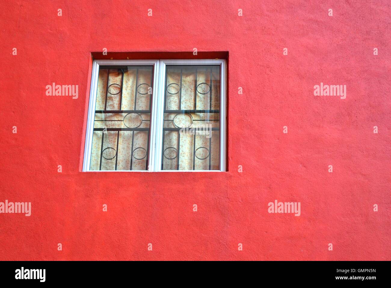 Window on an old red wall Stock Photo - Alamy