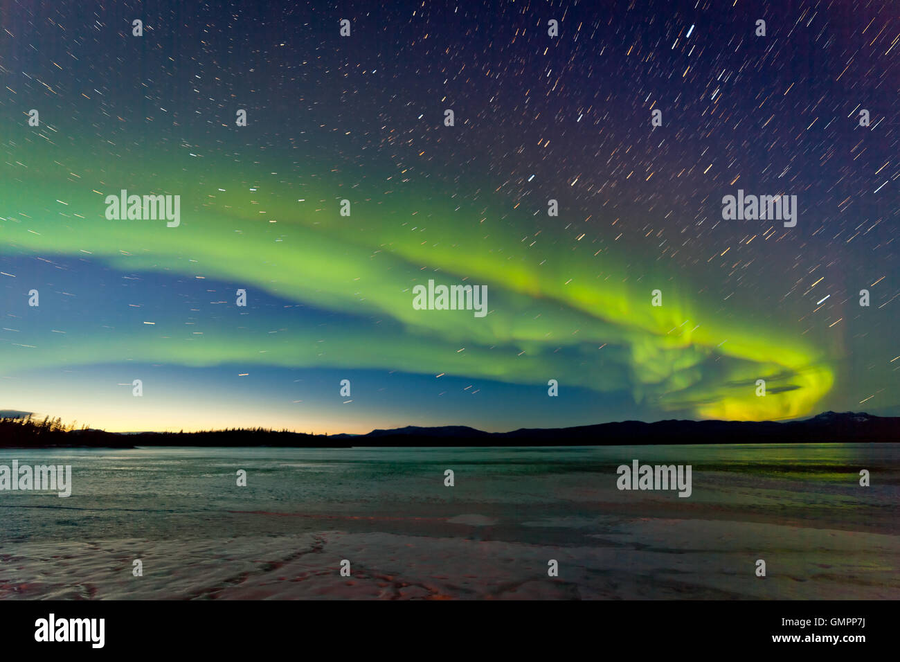 Northern Lights and morning dawn over frozen lake Stock Photo - Alamy