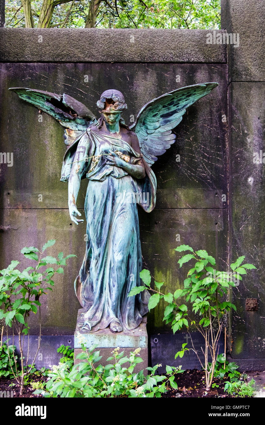 Angel statue sculpture on old grave at St. Hedwig Cemetery, Alter Domfriedhof St. Hedwig, Berlin. Stock Photo