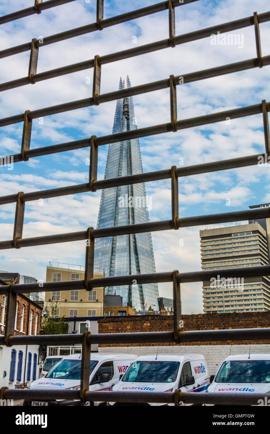 Views of the Shard from behind locked gates in SE London, UK Stock Photo