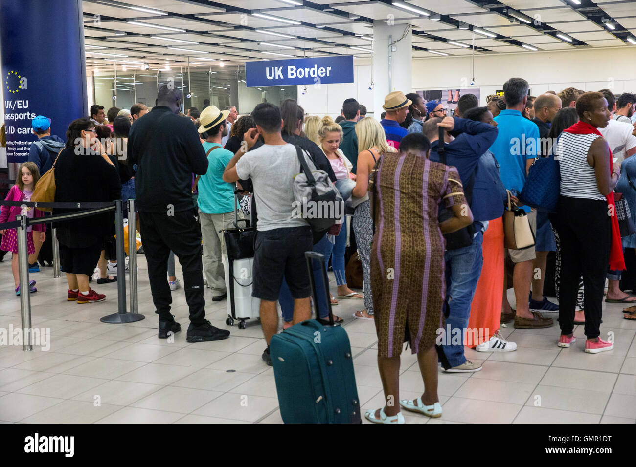 People queuing at the UK border immigration control at Gatwick South Terminal Stock Photo