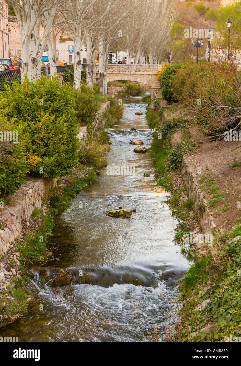 Small water canal crosses the city of Cuenca, Spain Stock Photo