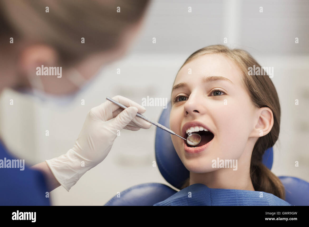female dentist checking patient girl teeth Stock Photo Alamy