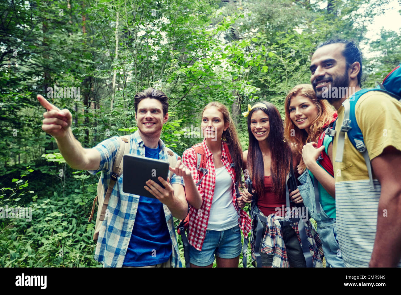 Happy friends backpacks tablet hi-res stock photography and images - Alamy