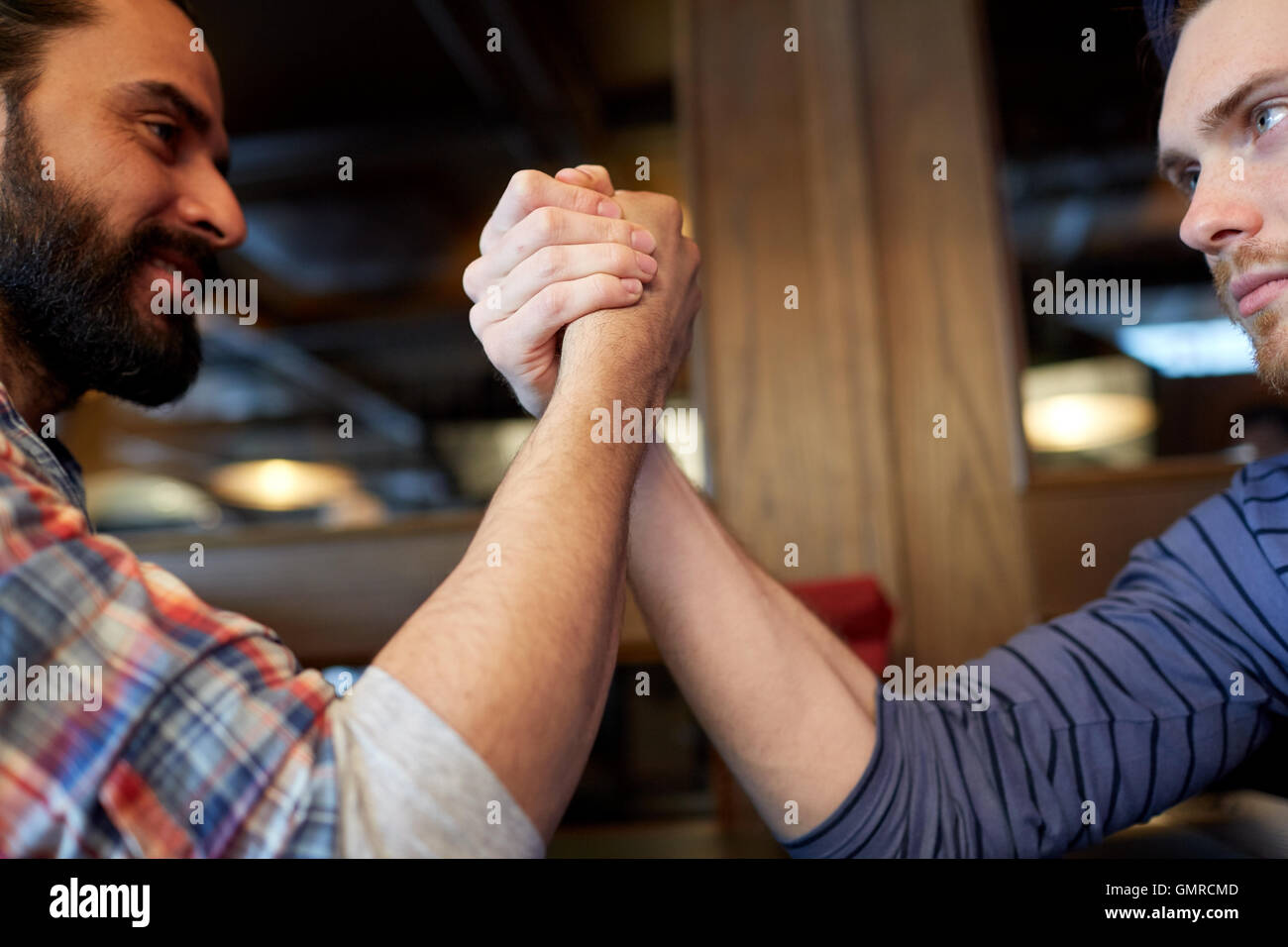 close up of men arm wrestling at bar or pub Stock Photo Alamy
