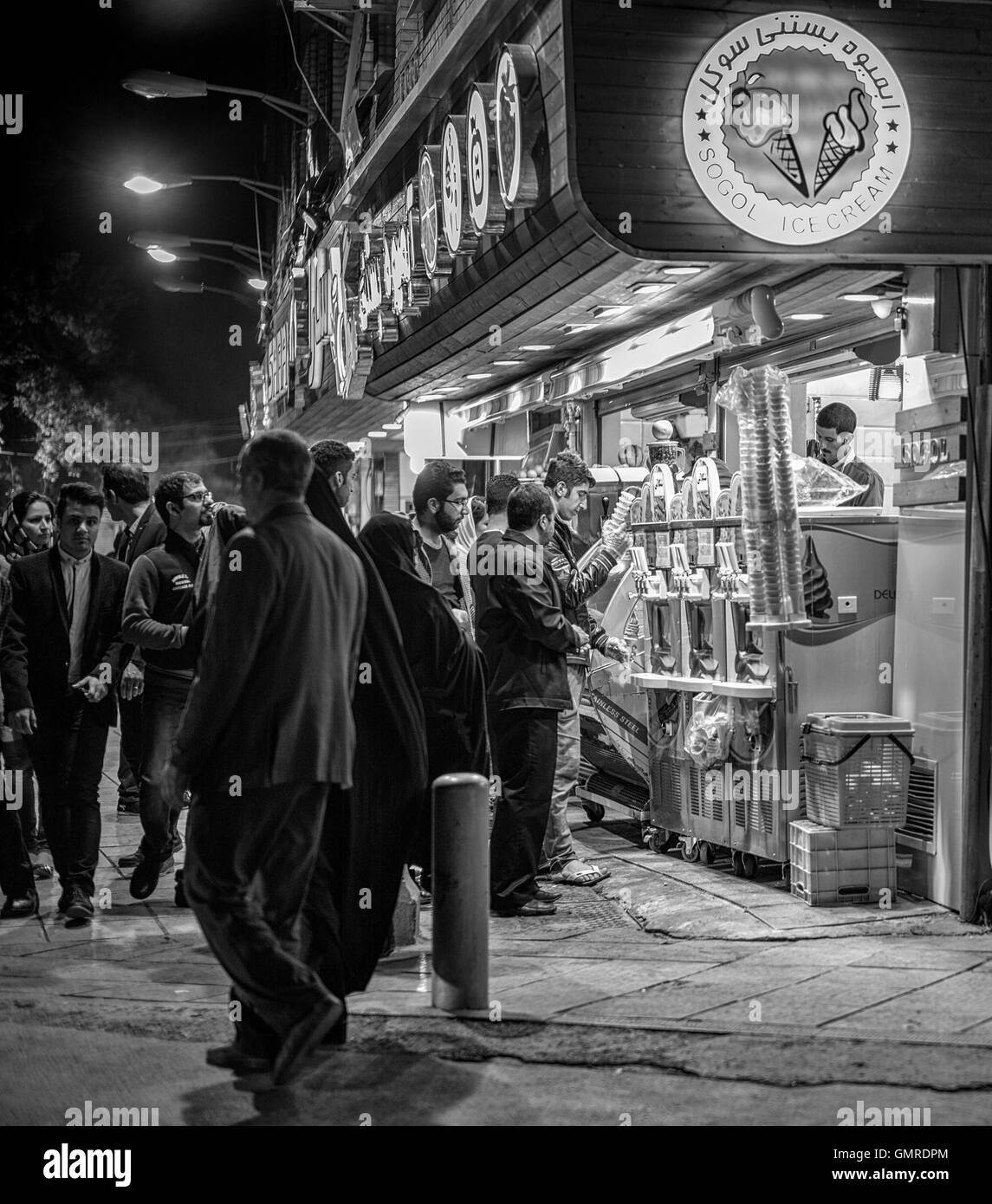 Crowd waiting to buy ice cream on the street at night in Isfahan, Iran. Stock Photo