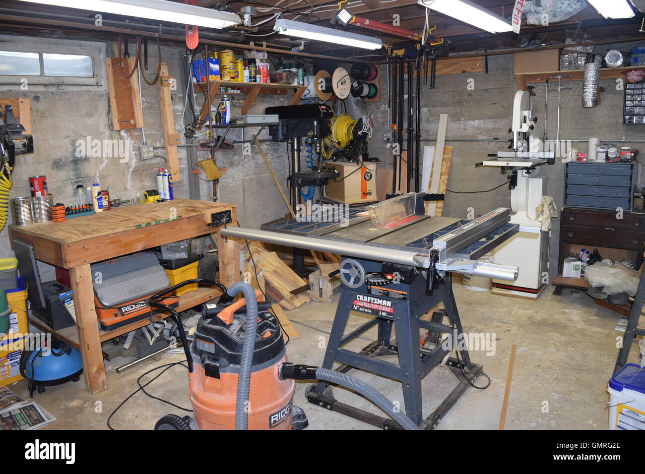Workshop Machinery Room with Table Saw, Shopvac and Band Saw Stock Photo