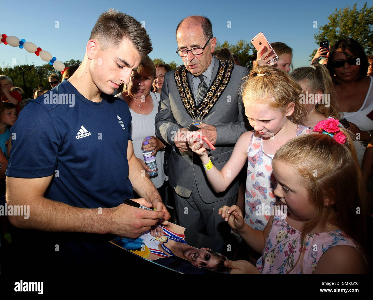 Team GB double Olympic Champion Max Whitlock signs autographs with local children during a homecoming event at South Essex Gymnastics Club, Basildon. Stock Photo