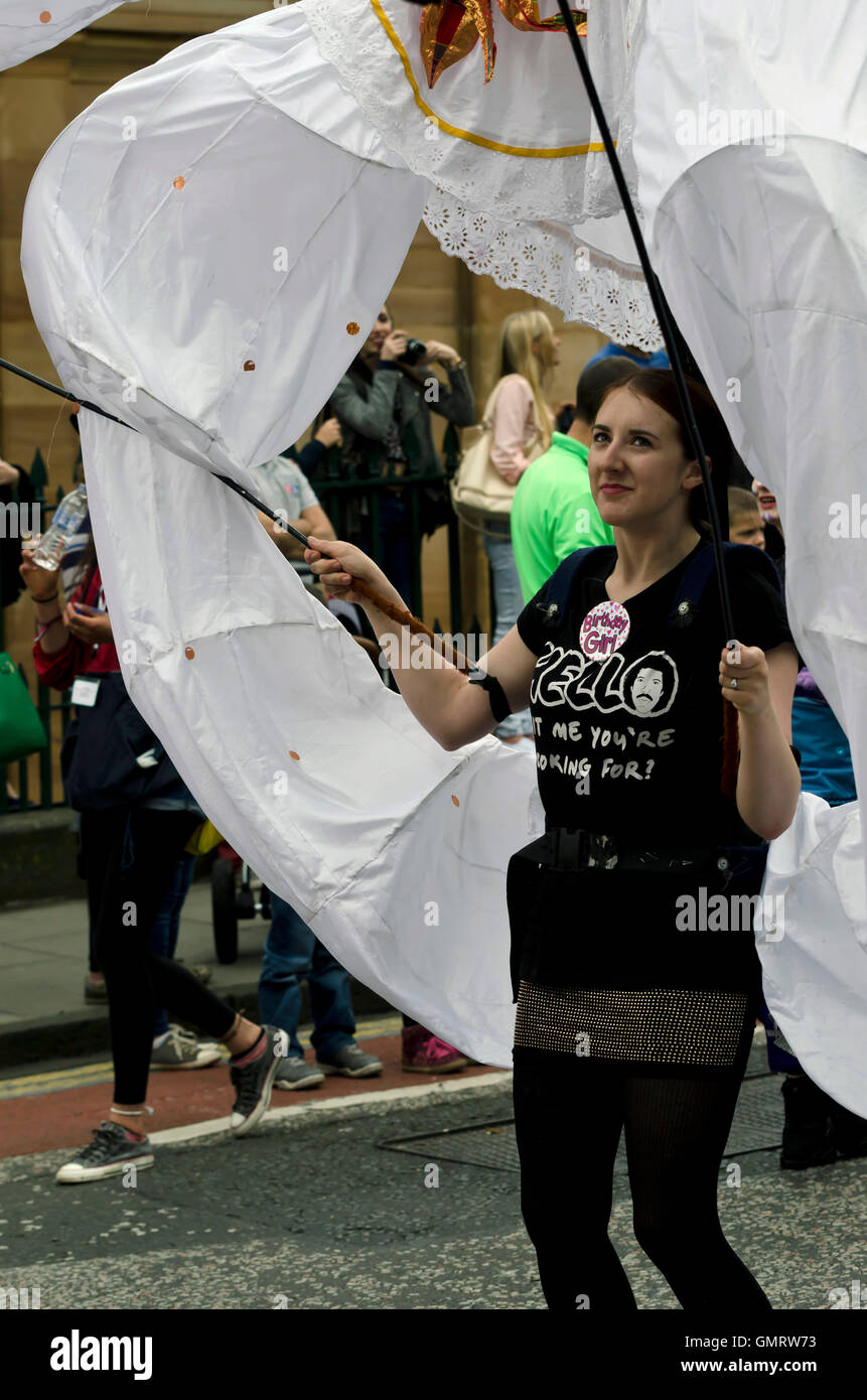 Woman carrying a large ornamental fabric ring taking part in the ...
