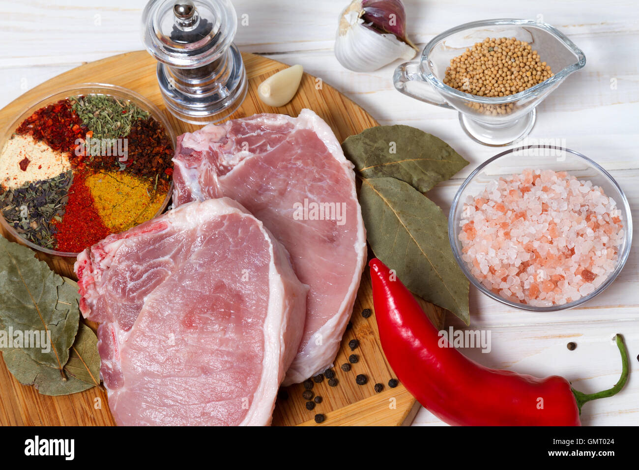 Entrecote and spices for cooking meat on a wooden board Stock Photo