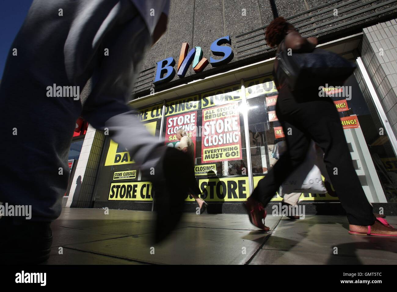 Pedestrians walk past the BHS store in Wood Green, London, as the last remaining stores are expected to close this weekend, with the doomed retailer set to disappear from the high street entirely by Sunday. Stock Photo
