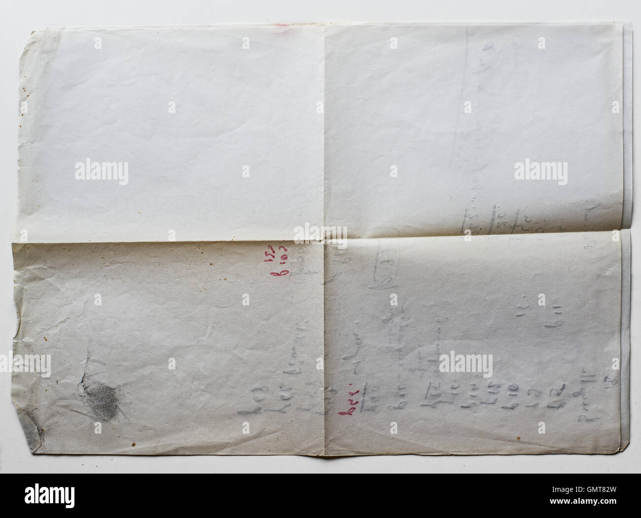 Old grunge paper on white background with handwriting on the reverse. Stock Photo
