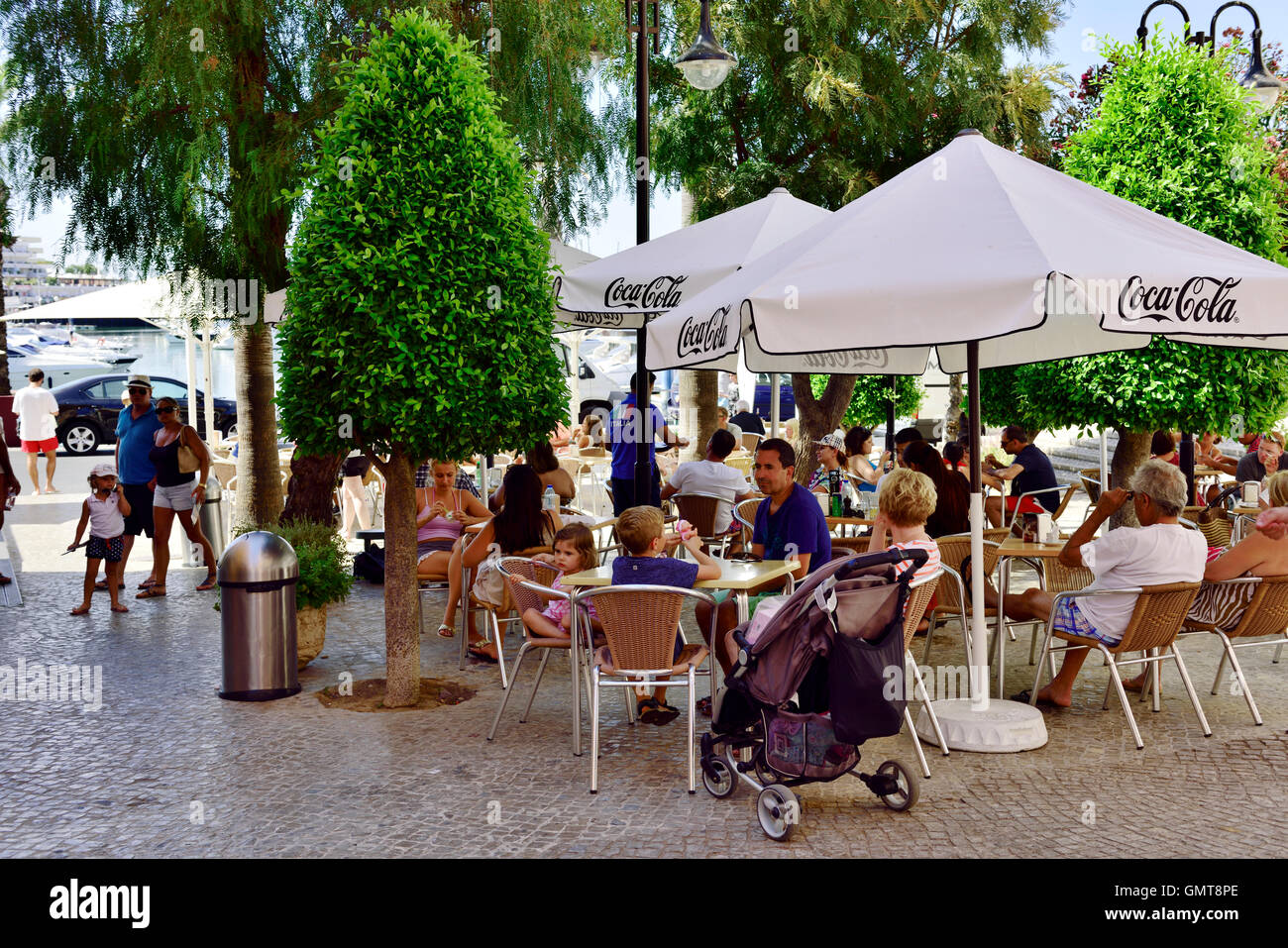 Tourists at outside restaurant in Quarteira, Algarve, south Portugal Stock Photo