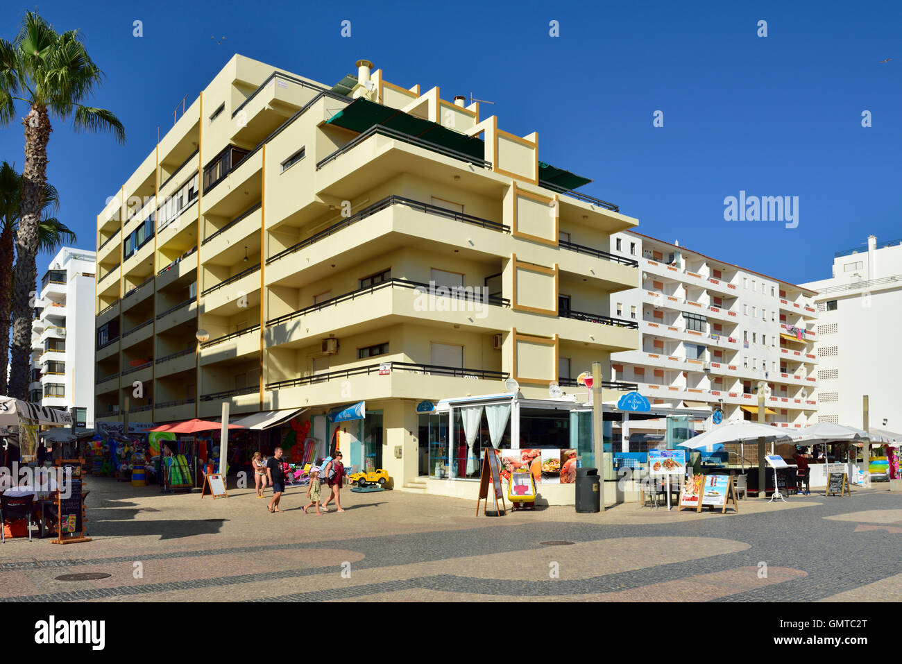 Seafront shops, cafes, hotels and apartments in Quarteira, Algarve, south Portugal Stock Photo