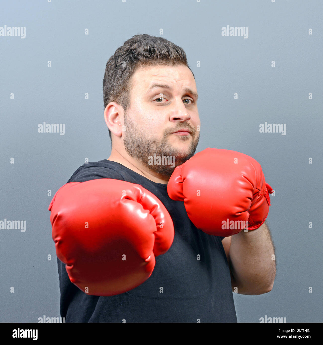 Portrait of chubby boxer posing with boxing gloves Stock Photo - Alamy