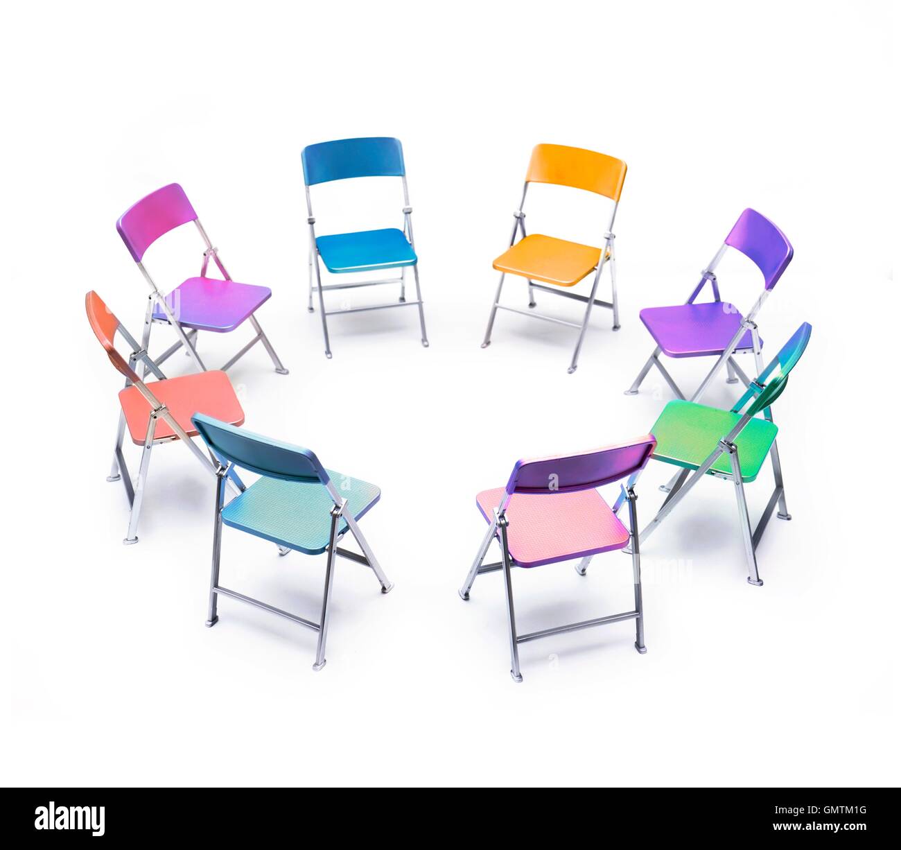 Circle of chairs of different colours Stock Photo - Alamy