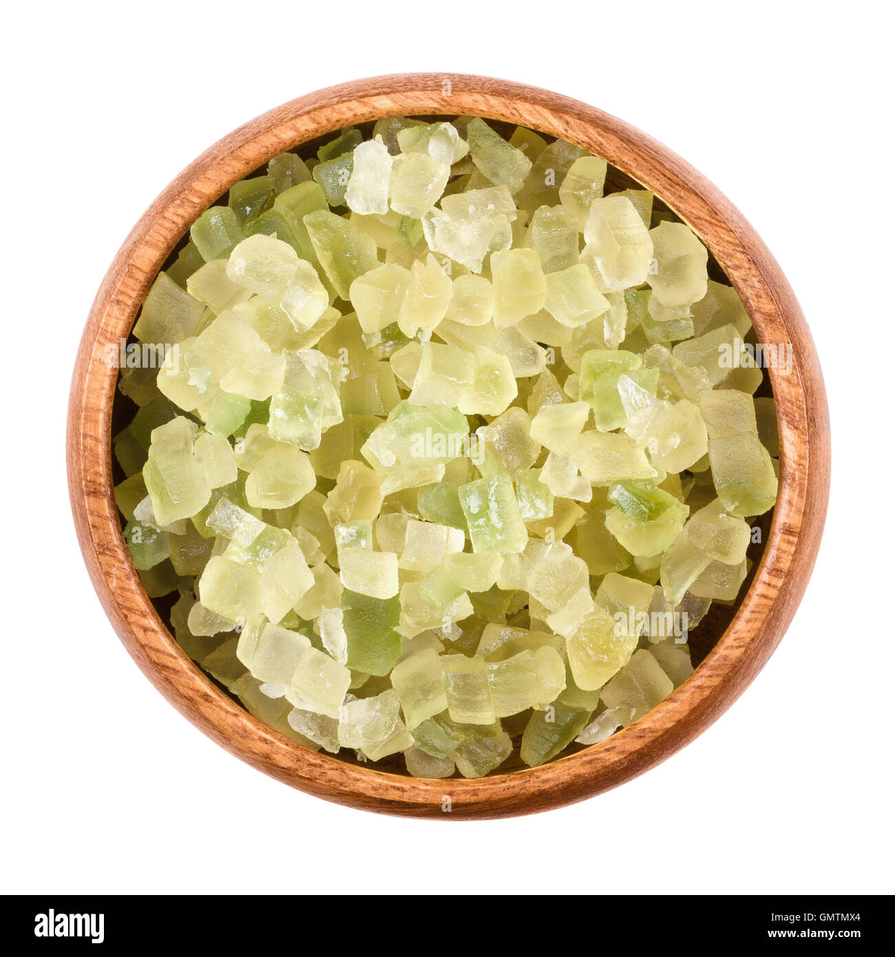 Diced green colored succade in a wooden bowl on white background. Candied peel of the citron fruit, Citrus medica. Stock Photo
