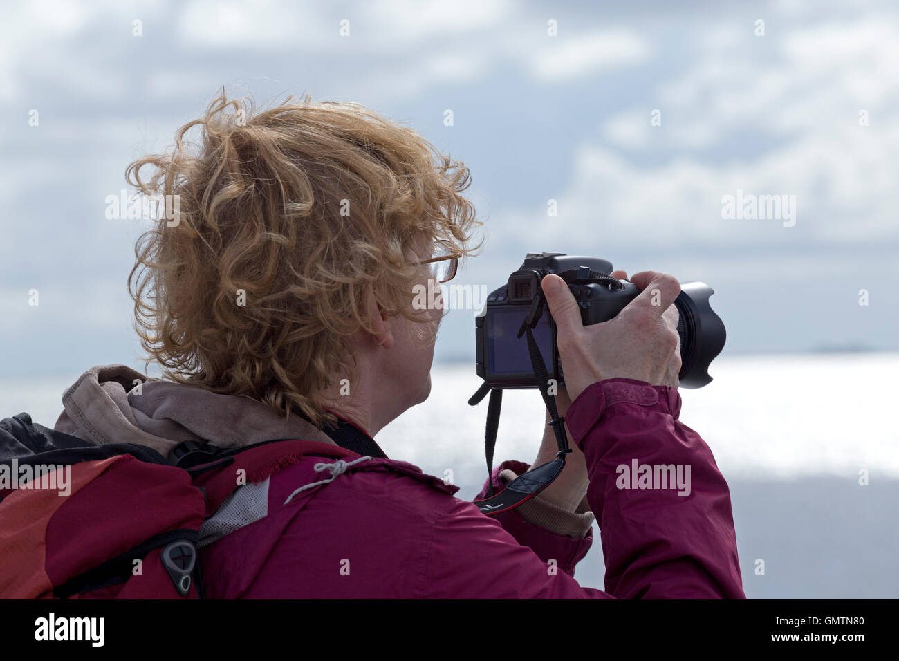 woman taking photographs on the ferry to Amrum Island, North Friesland, Schleswig-Holstein, Germany Stock Photo