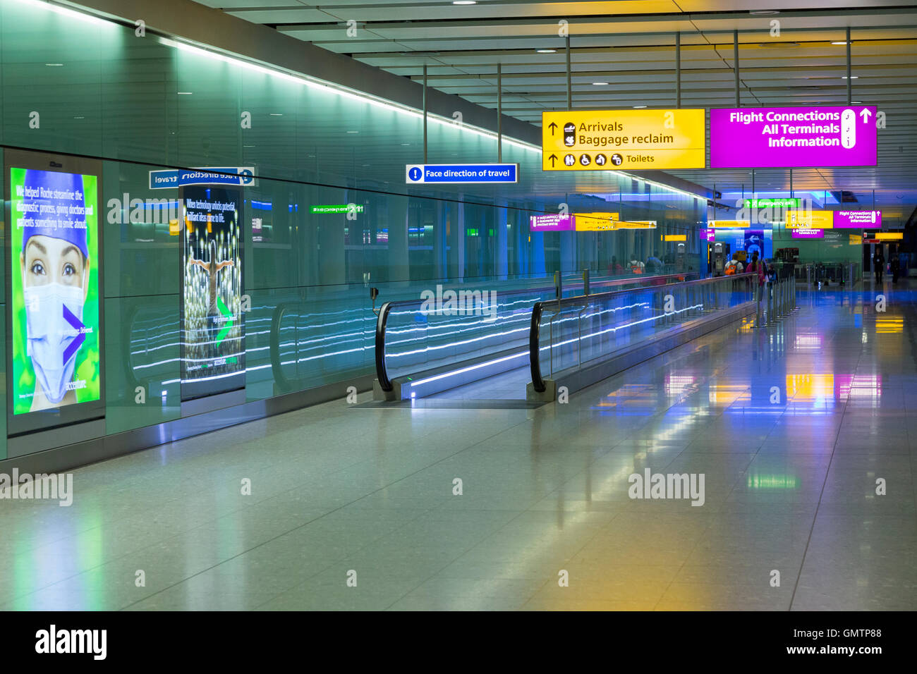 Heathrow Airport corridor / hall leading to arrivals after alighting from airplane & entering airport terminal 2. LHR London UK Stock Photo
