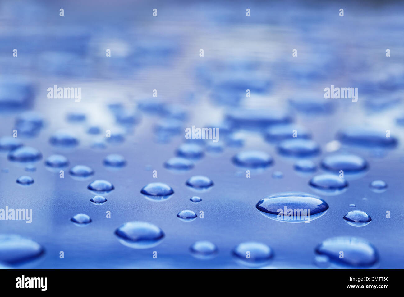 water drops on blue car body threated with protective coating Stock Photo