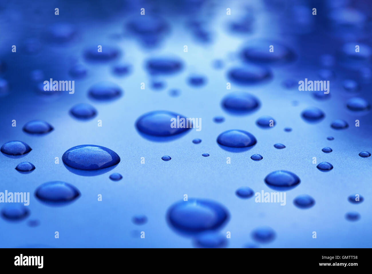 water drops on blue car body threated with protective coating Stock Photo