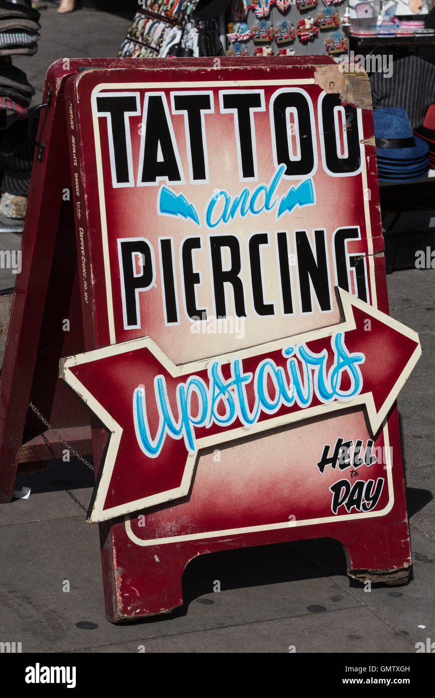 Tattoo and Piercing shop, sign at Camden Lock Market, Camden, London