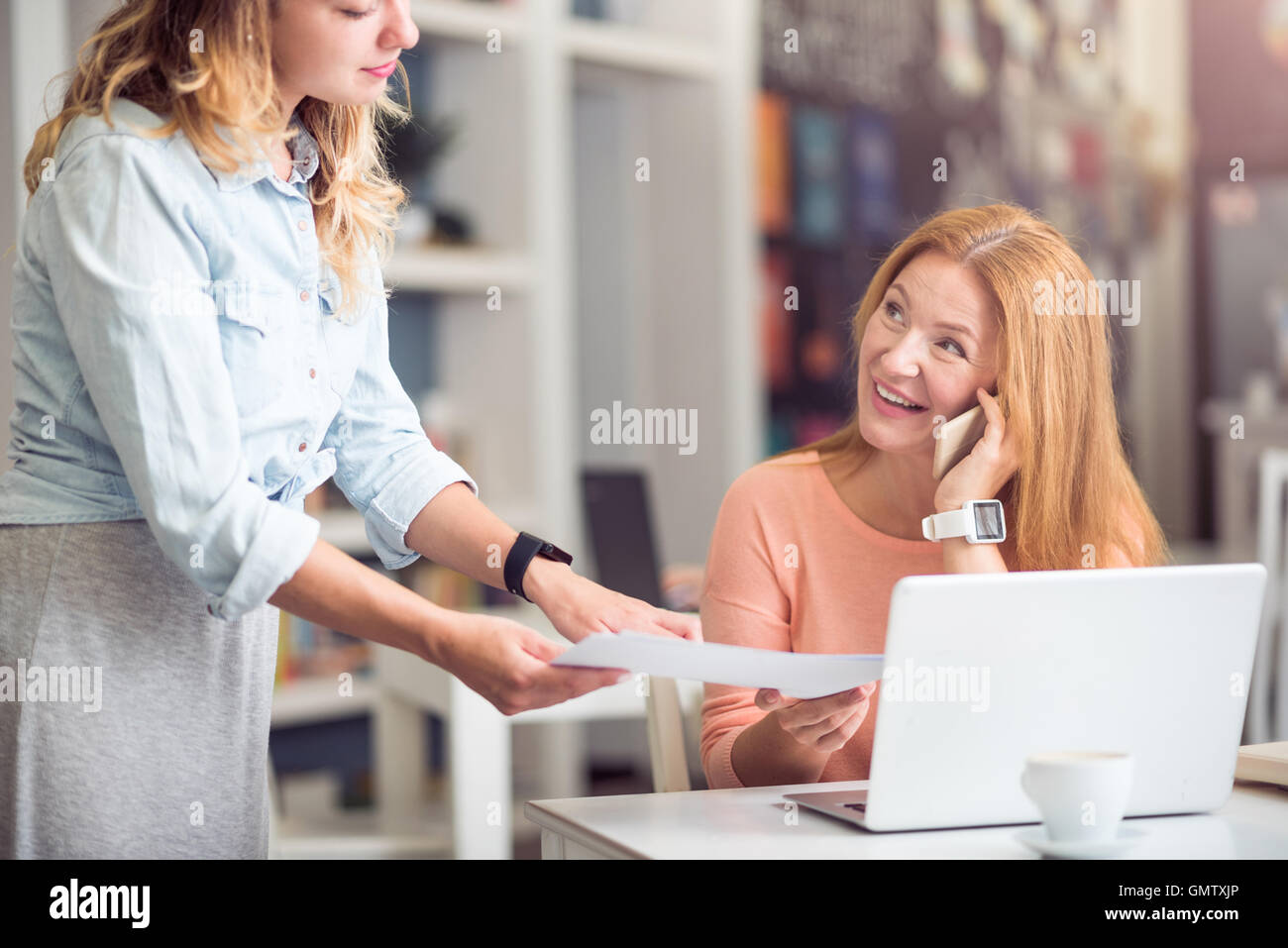 Cheerful woman sitting at the table Stock Photo - Alamy