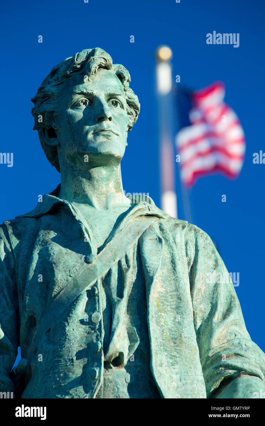 Captain Parker statue on Battle Green with American flag, Lexington Green, Lexington, Massachusetts Stock Photo