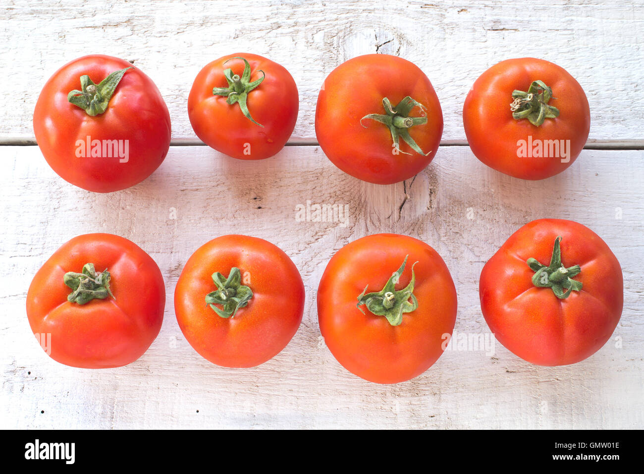 Tomatoes on white wooden surface Stock Photo