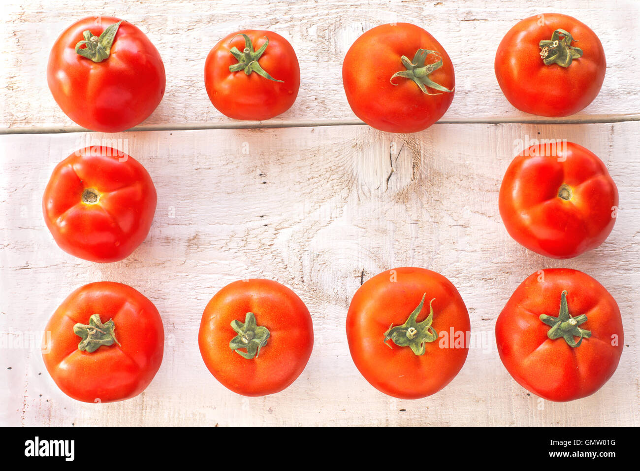 Tomatoes on white wooden surface Stock Photo