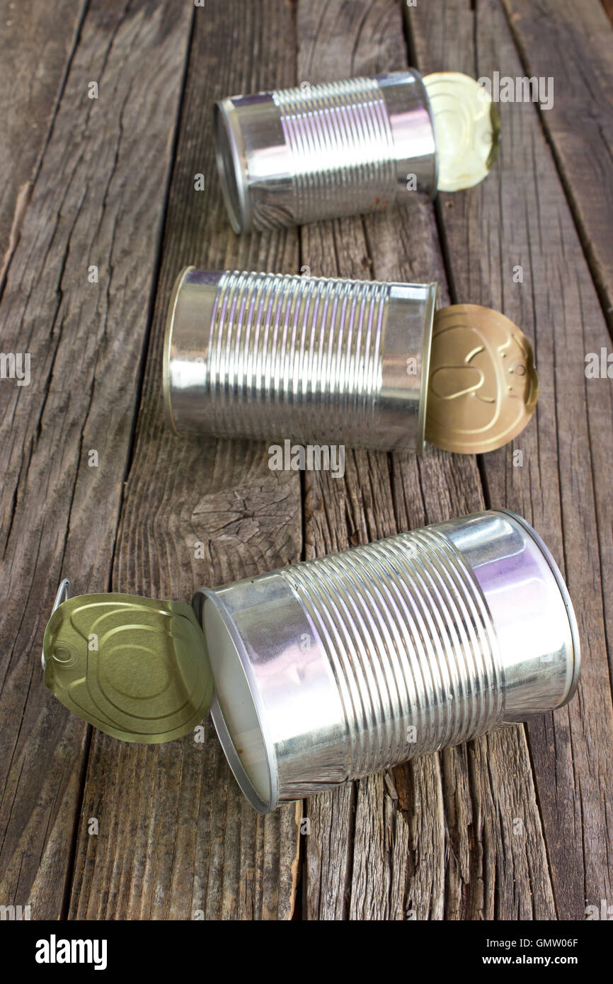 Open empty tin can on wooden background Stock Photo