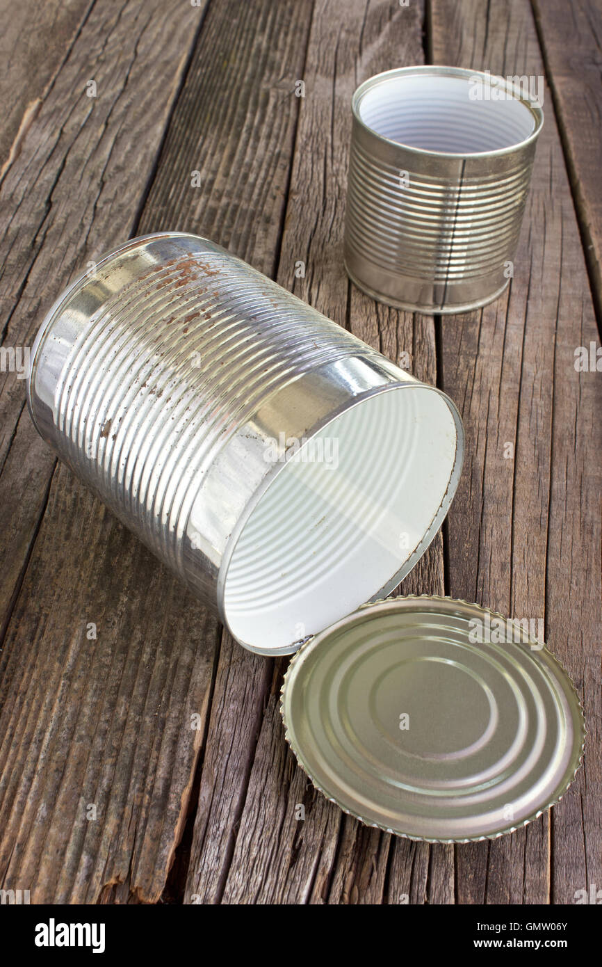 Open empty tin can on wooden background Stock Photo