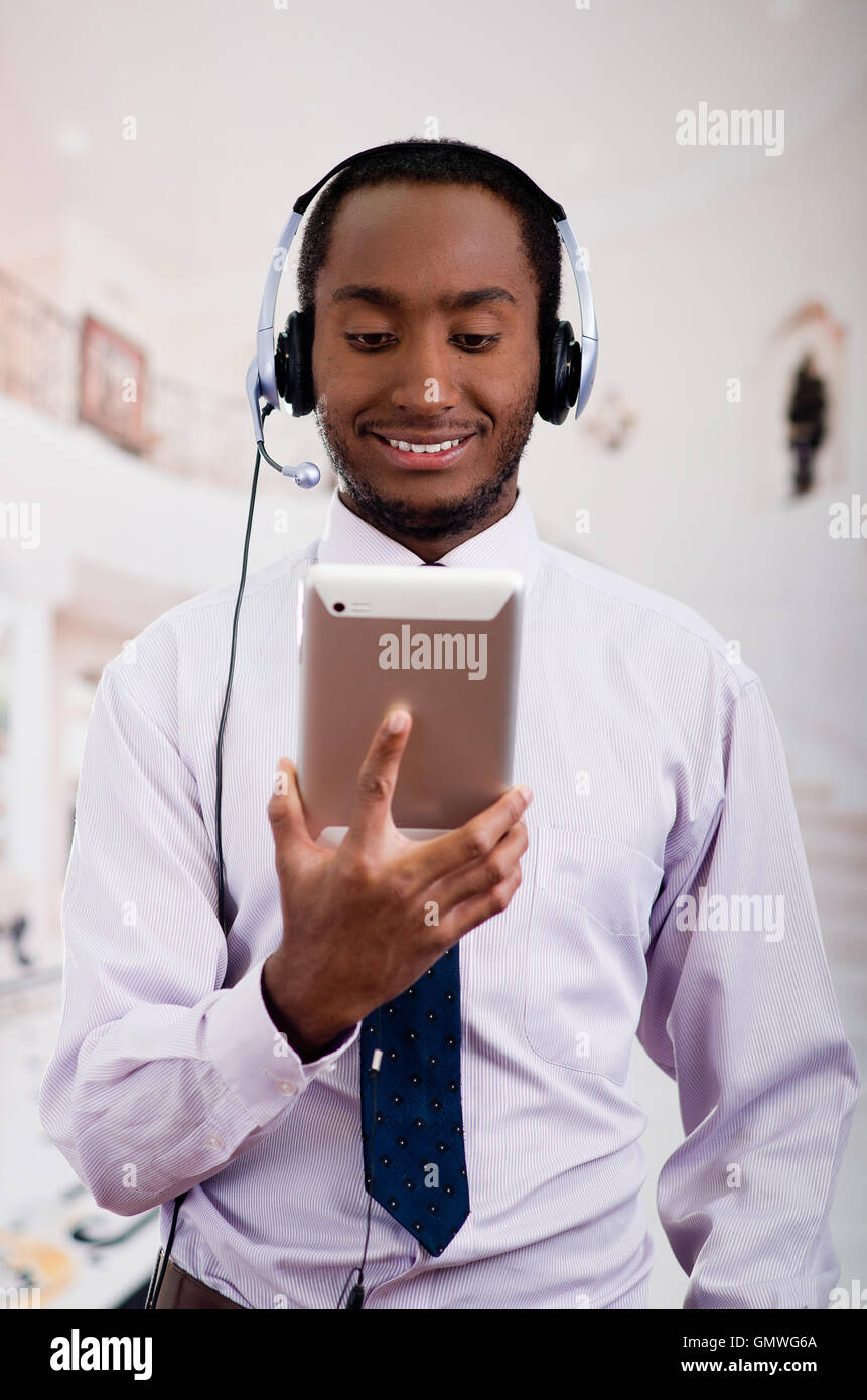 Handsome man wearing headphones with microphone, white striped shirt