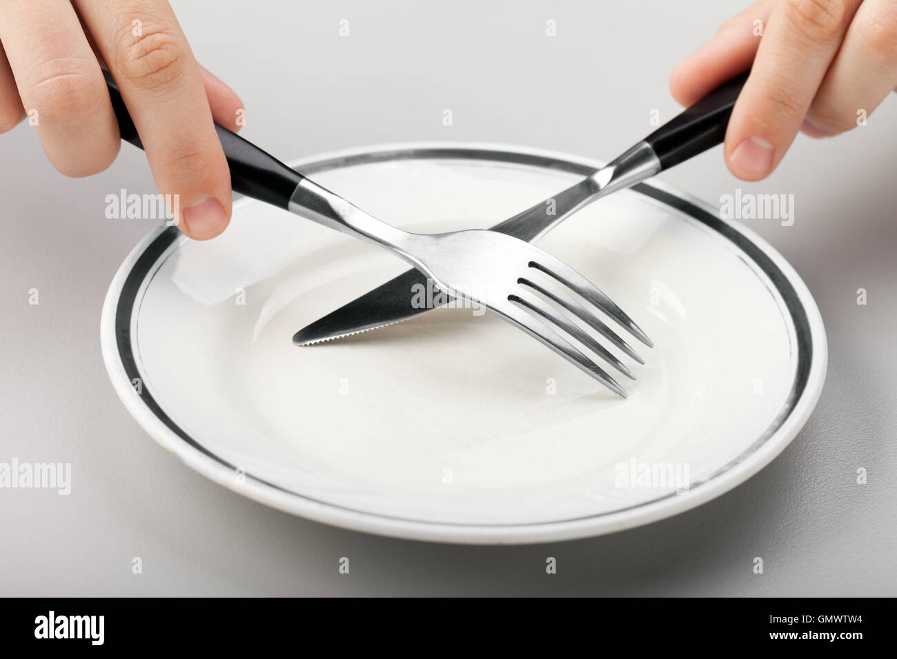 Hand holding fork and knife Stock Photo Alamy