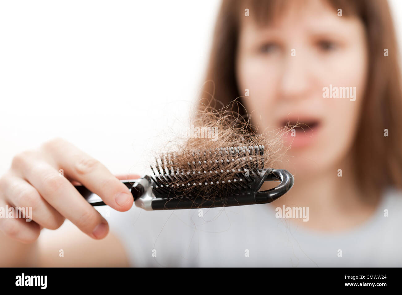 Loss hair comb in women hand Stock Photo