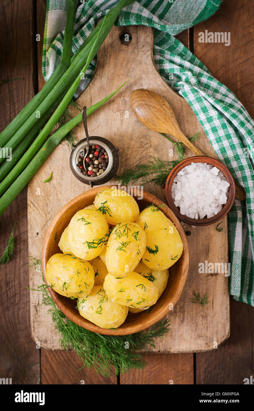Boiled new potatoes seasoned with dill and butter. Top view Stock Photo