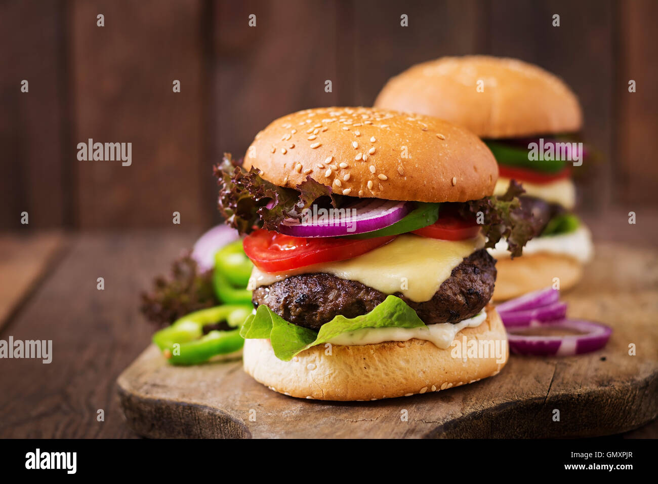 Big sandwich hamburger burger with beef, cheese, tomato and tartar