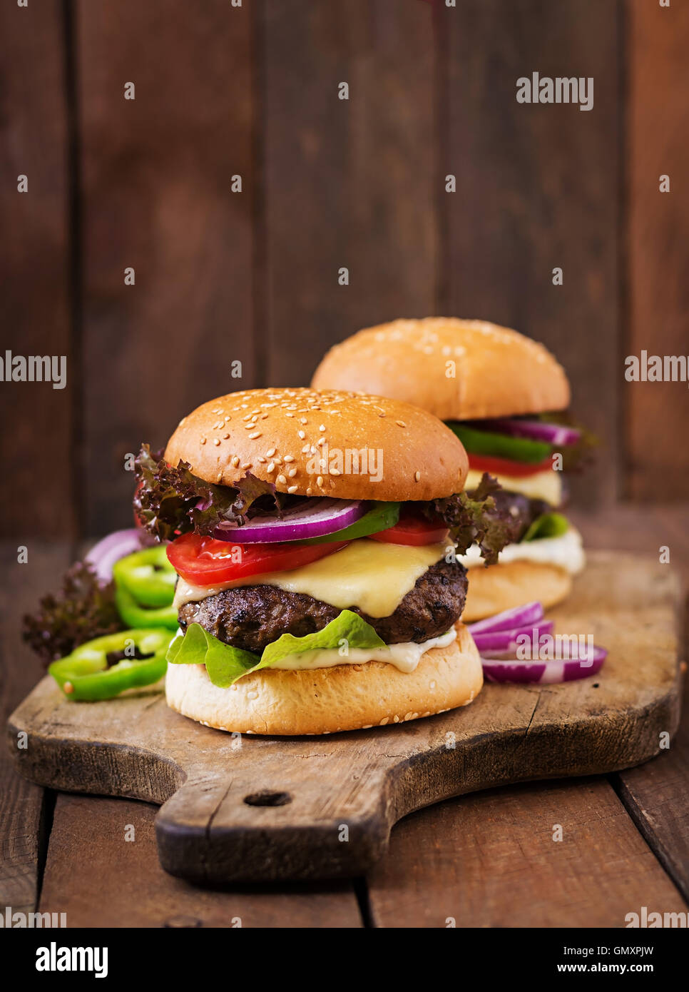 Big sandwich hamburger burger with beef, cheese, tomato and tartar