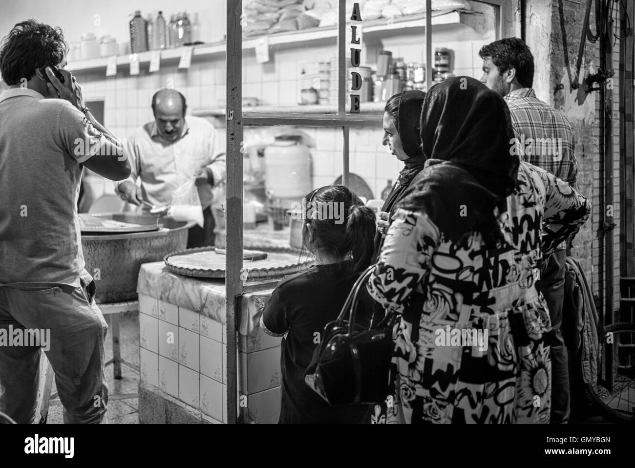 Crowd waiting outside popular faloodeh shop for the sweet noodle dessert in Yazd, Iran. Stock Photo