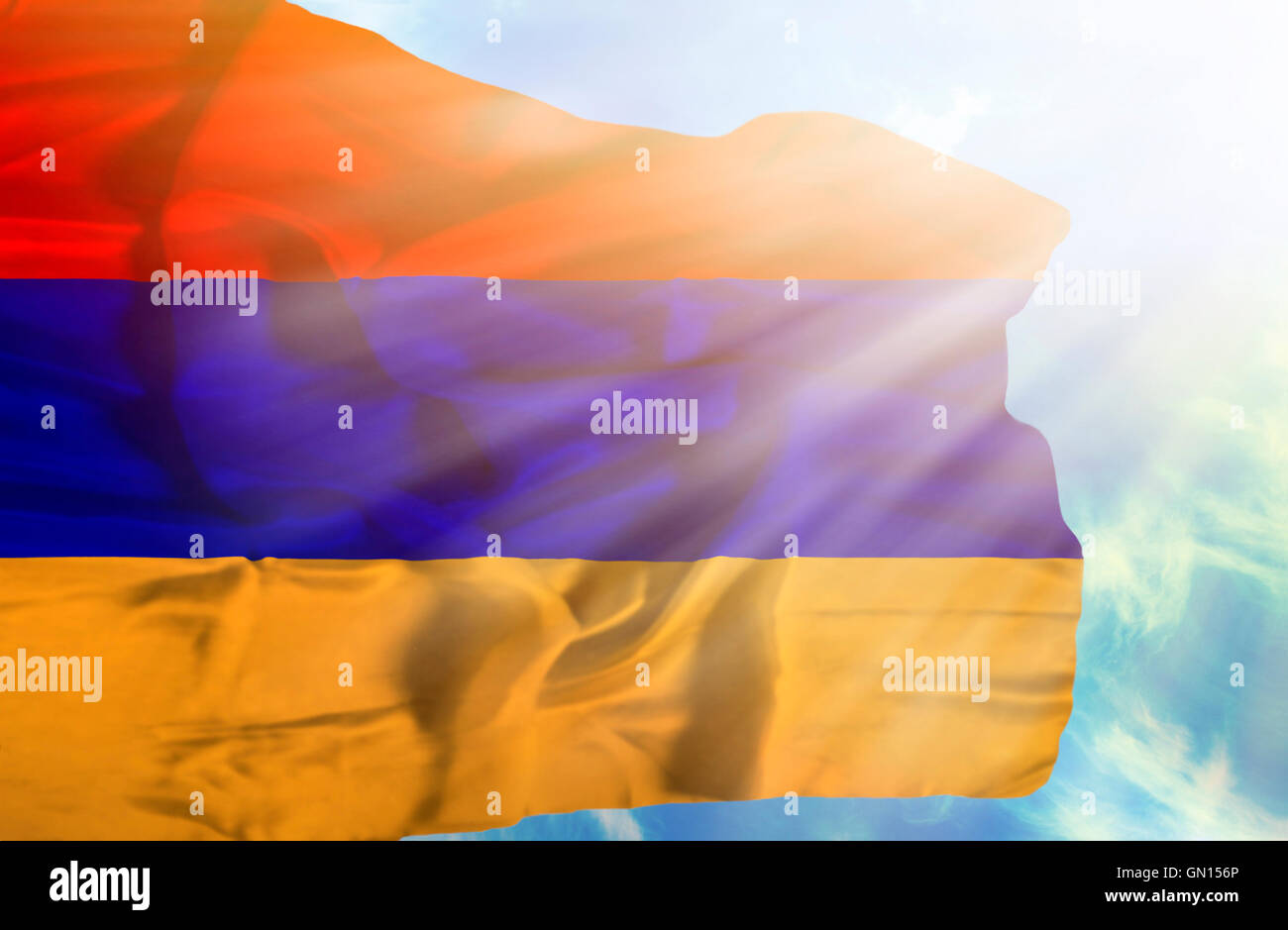 Armenia waving flag against blue sky with sunrays Stock Photo - Alamy