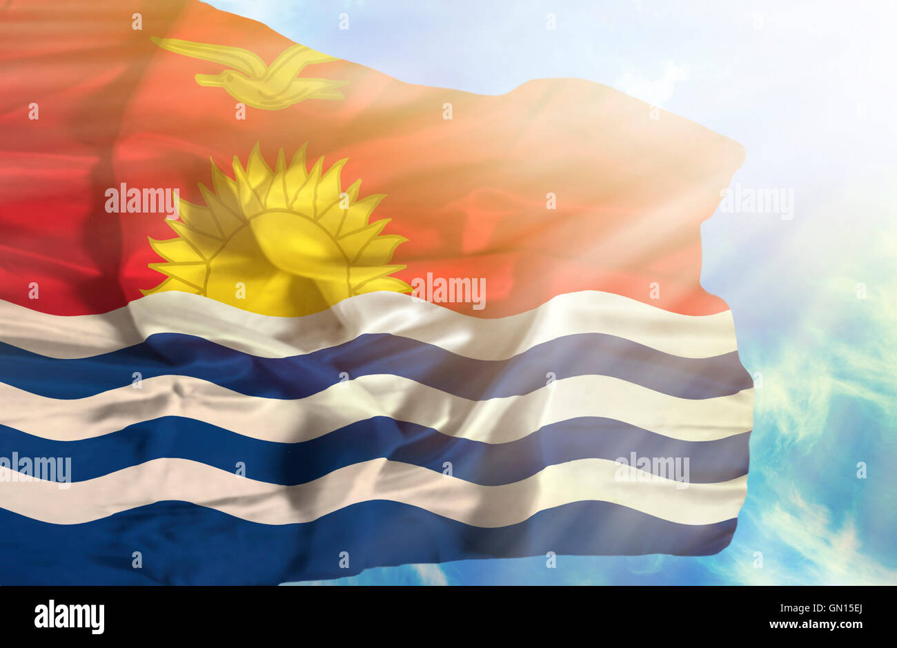 Kiribati waving flag against blue sky with sunrays Stock Photo - Alamy