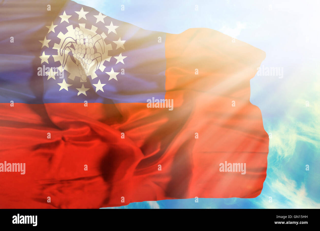 Myanmar waving flag against blue sky with sunrays Stock Photo - Alamy