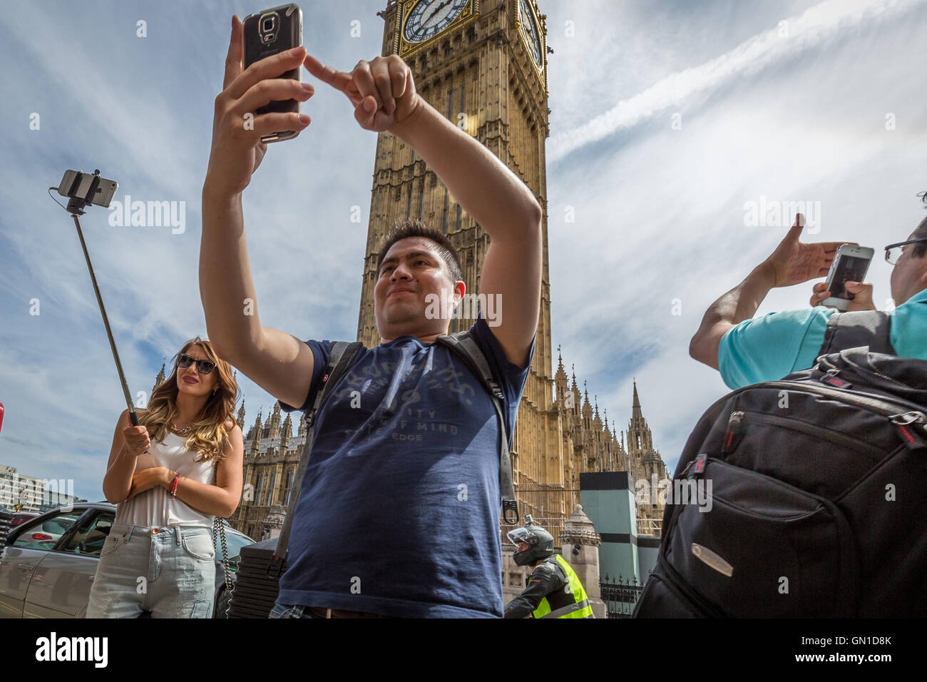 Tourists taking photos and phone selfies around Westminster, London, UK. Stock Photo
