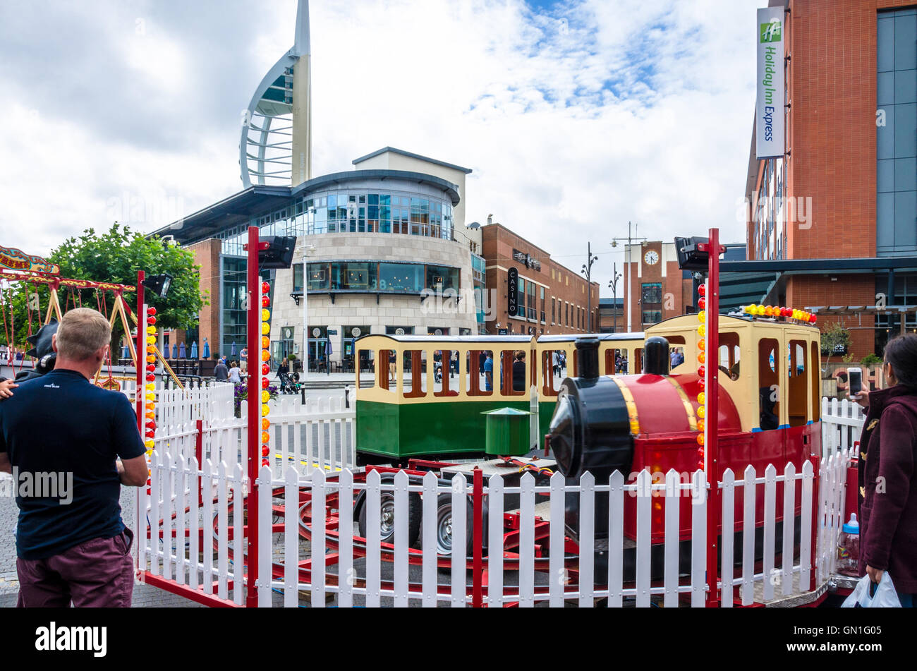 A children's train ride at a small fair at Gunwharf Quays in Portsmouth. Stock Photo